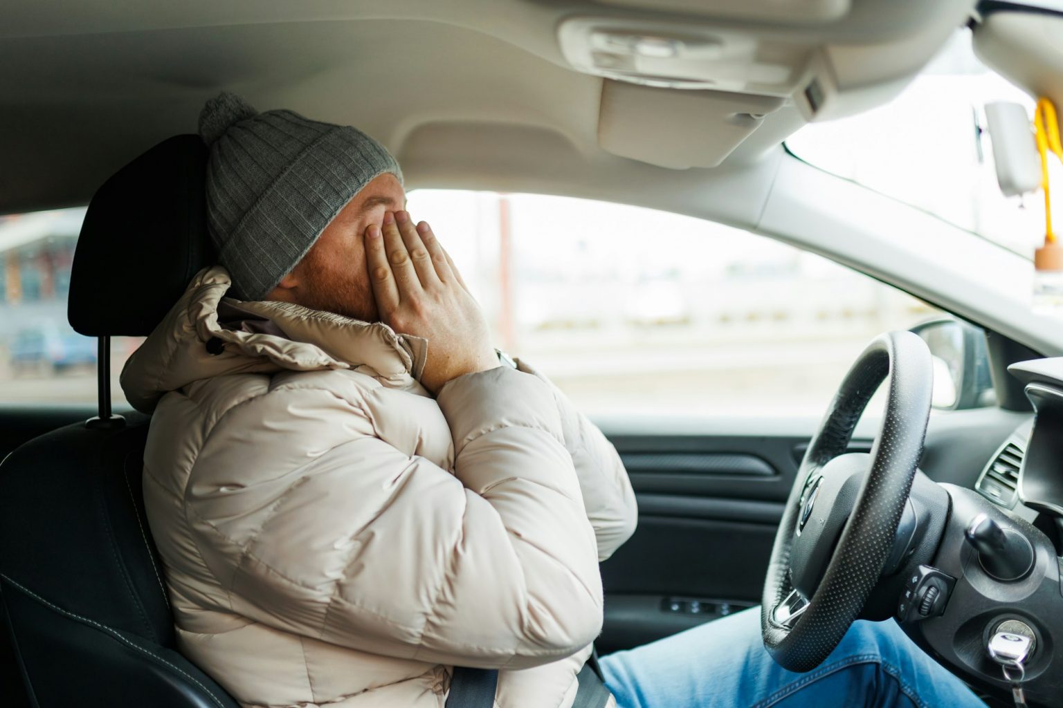 bearded man driver, he is very tired and falls asleep at the wheel