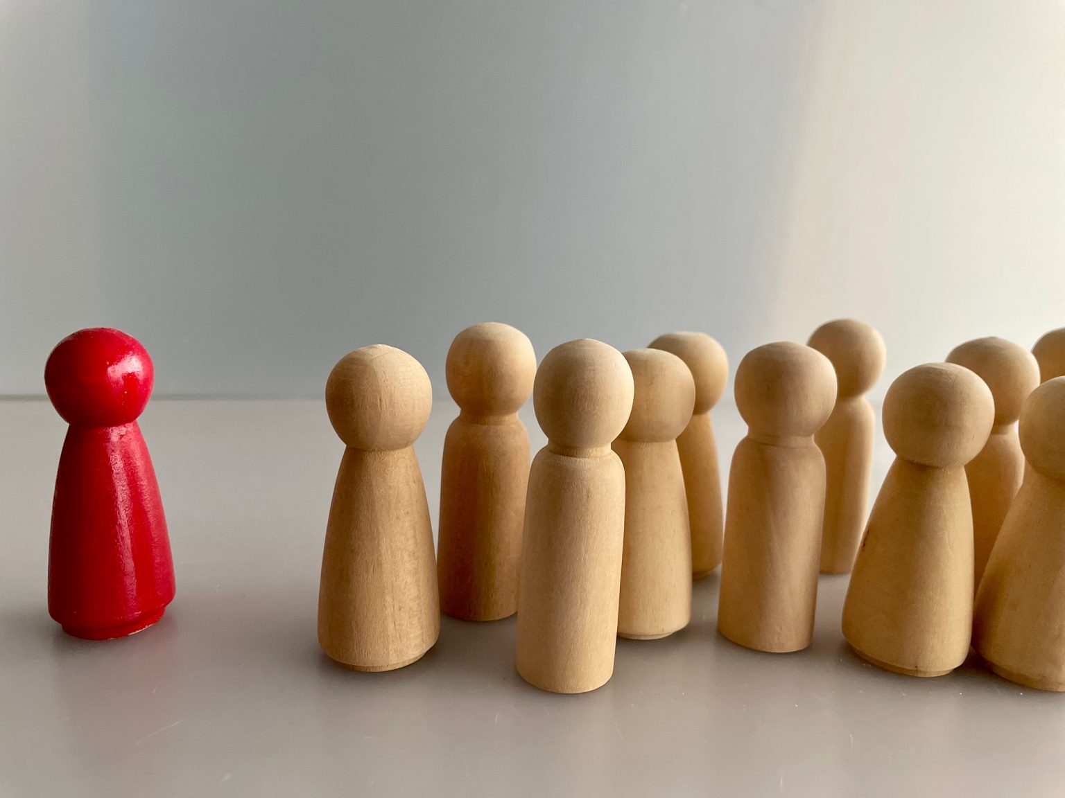Close-up shot of wooden figures on a grey background
