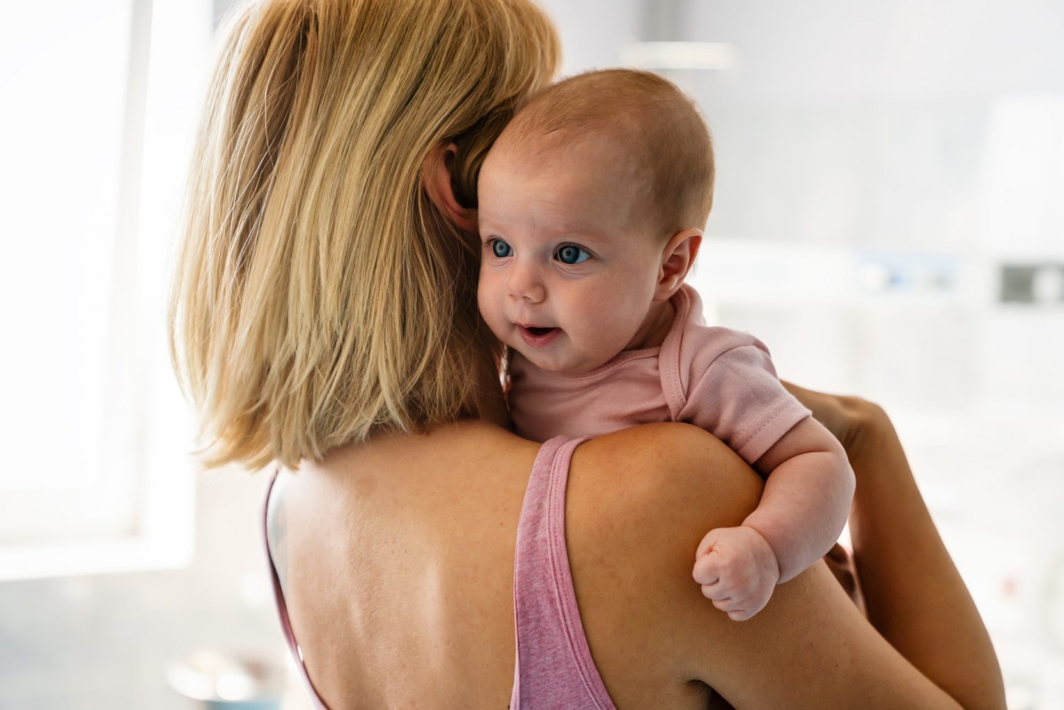 Happy cheerful family. Mother and baby kissing, laughing and hugging